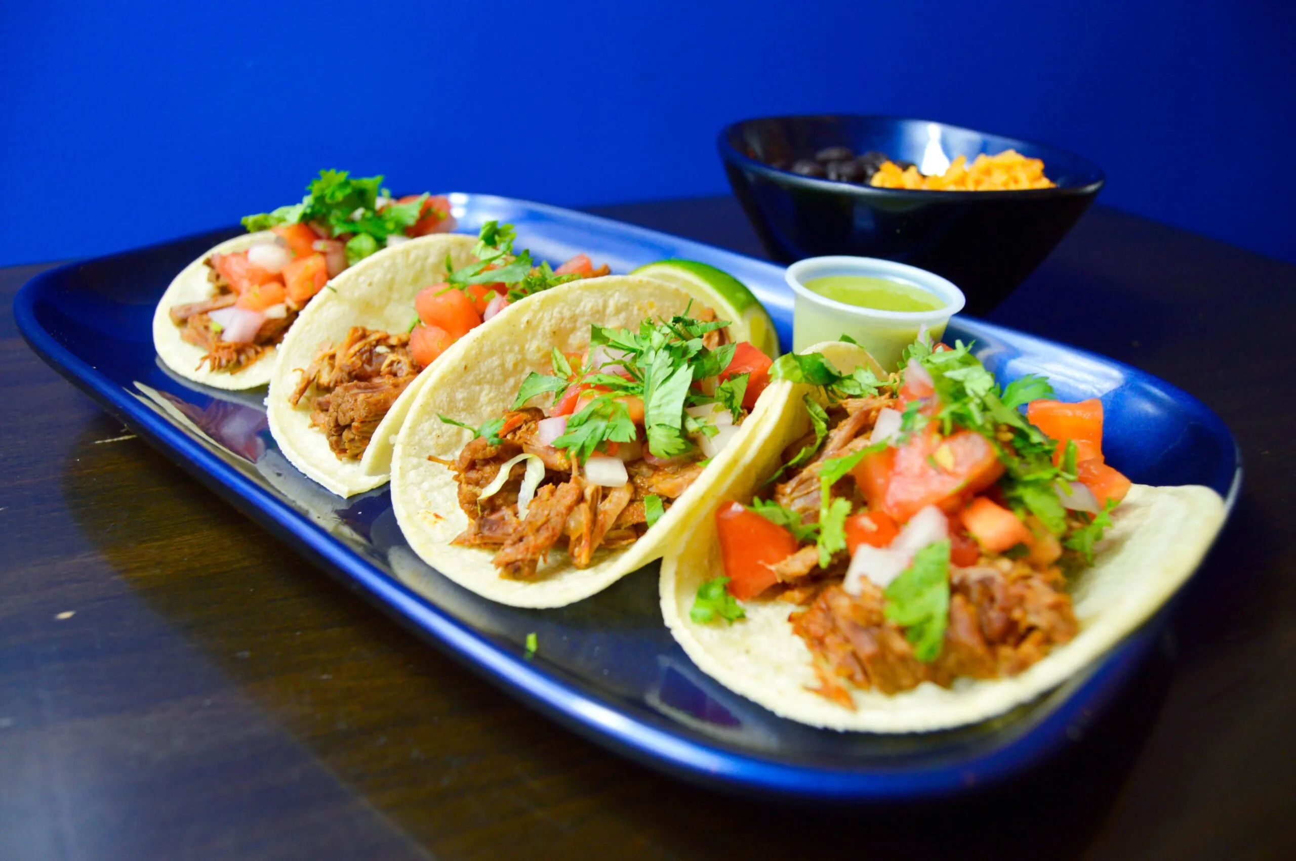 Street tacos topped with cilantro and onion